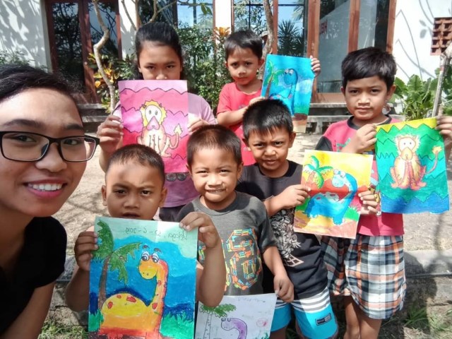 Volunteer art teacher Mega with local children and the outcome of one of her weekly art workshops.