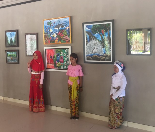 Artists pose with their works during the opening of during the opening of "Art Exhibition by Children Sanggar Bares - There is no Truth only HONESTY" 12 – 31 October at the Nyana Tilem Museum, in Mas. Image courtesy Soemantri Widagdo
